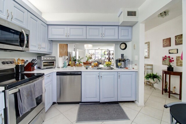 2524 NW 104th Ave Unit 101, Sunrise, FL 33322 - kitchen with appliances with stainless steel finishes, light countertops, and light tile patterned flooring