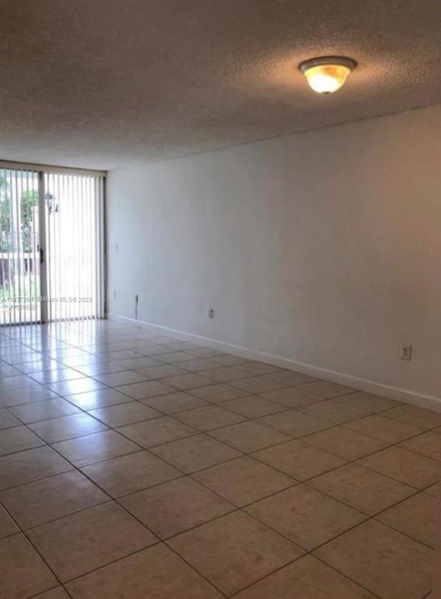 4653 NW 97 Unit 21, Doral, FL 33178 - spare room with a textured ceiling and baseboards