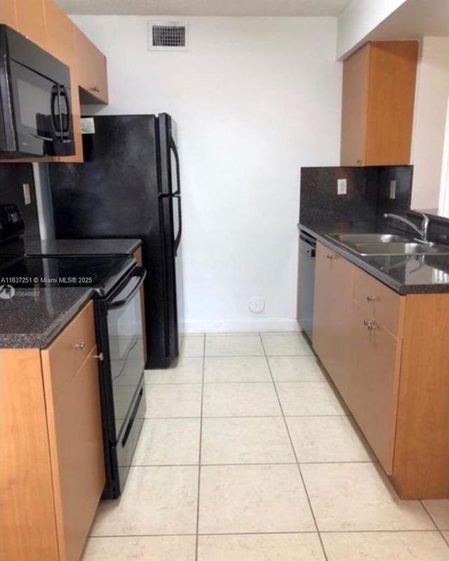 4653 NW 97 Unit 21, Doral, FL 33178 - kitchen featuring black appliances, light tile patterned floors, tasteful backsplash, and dark stone countertops