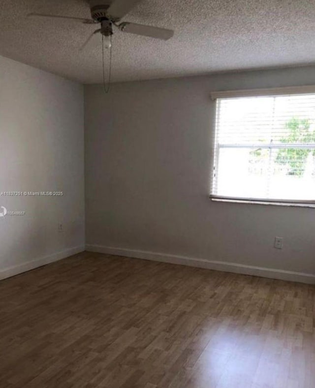 4653 NW 97 Unit 21, Doral, FL 33178 - empty room featuring wood finished floors, ceiling fan, and a textured ceiling