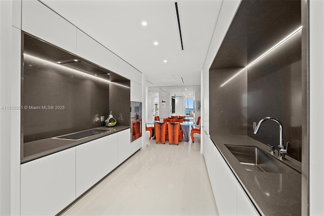 300 Biscayne Boulevard Way Unit 2703, Miami, FL 33131 - kitchen featuring modern cabinets, white cabinets, dark countertops, and black electric cooktop