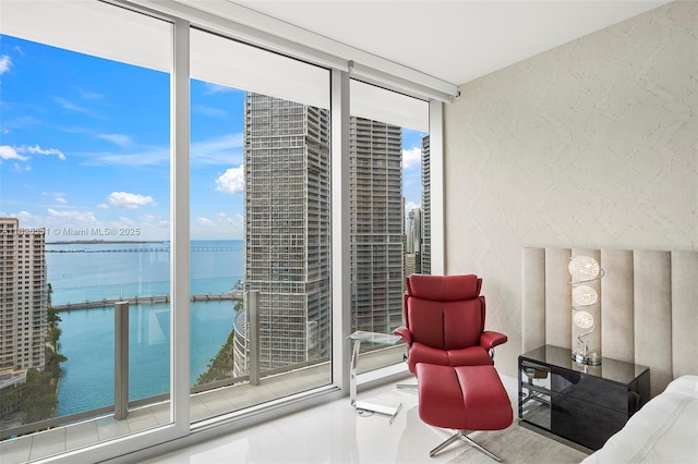 300 Biscayne Boulevard Way Unit 2703, Miami, FL 33131 - bedroom featuring a water view, a textured wall, and a wall of windows