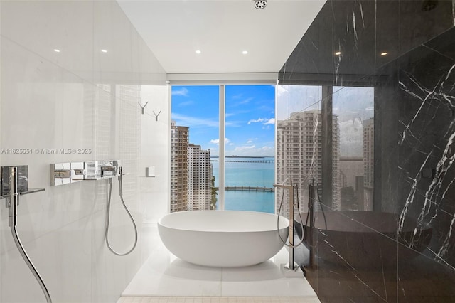 300 Biscayne Boulevard Way Unit 2703, Miami, FL 33131 - bathroom featuring a walk in shower, a soaking tub, and a water view