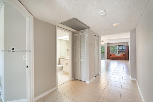 1000 SW 128th Ter Unit 312V, Pembroke Pines, FL 33027 - hallway with a textured ceiling and light tile patterned floors