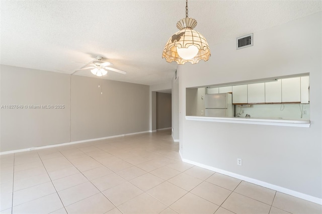 1000 SW 128th Ter Unit 312V, Pembroke Pines, FL 33027 - spare room featuring a ceiling fan, a textured ceiling, and light tile patterned floors