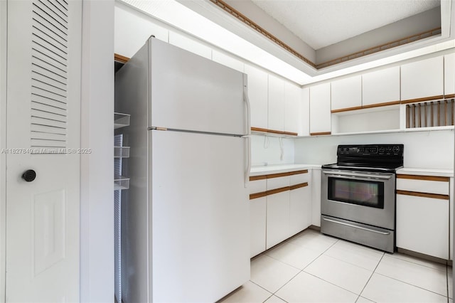 1000 SW 128th Ter Unit 312V, Pembroke Pines, FL 33027 - kitchen featuring freestanding refrigerator, stainless steel range with electric stovetop, light countertops, and white cabinets