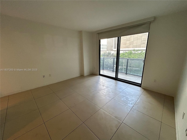 31 SE 6th St Unit 407, Miami, FL 33131 - empty room featuring floor to ceiling windows and light tile patterned flooring