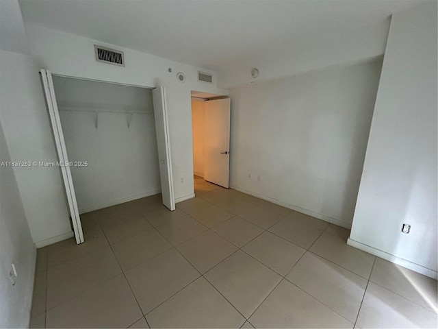 31 SE 6th St Unit 407, Miami, FL 33131 - unfurnished bedroom featuring a closet and light tile patterned flooring