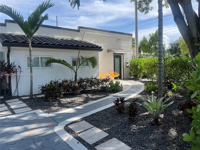 2301 SW 17th Ave, Miami, FL 33145 - view of front of home with a tile roof and stucco siding