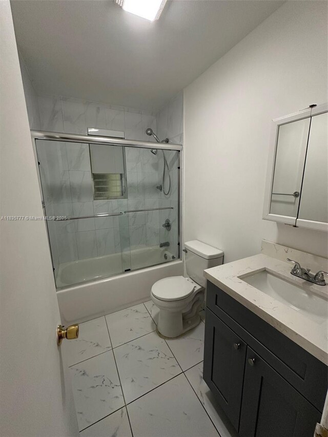 6547 SW 35th St, Miami, FL 33155 - bathroom with marble finish flooring, vanity, and bath / shower combo with glass door