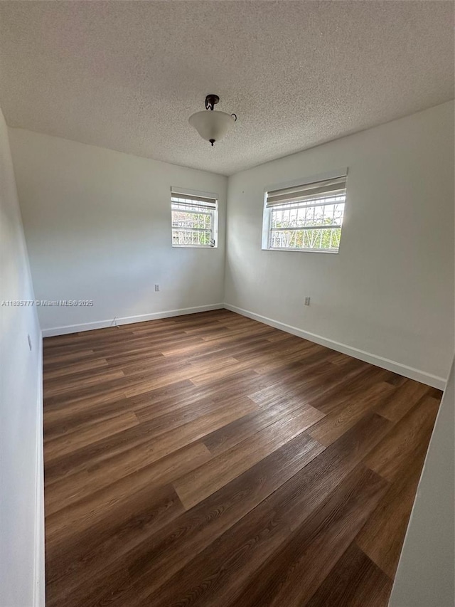 6547 SW 35th St, Miami, FL 33155 - empty room featuring dark wood-style flooring and a textured ceiling