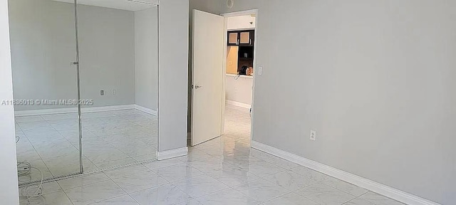 800 N Miami Ave Unit E-707, Miami, FL 33136 - unfurnished bedroom featuring a closet and light marble finish flooring