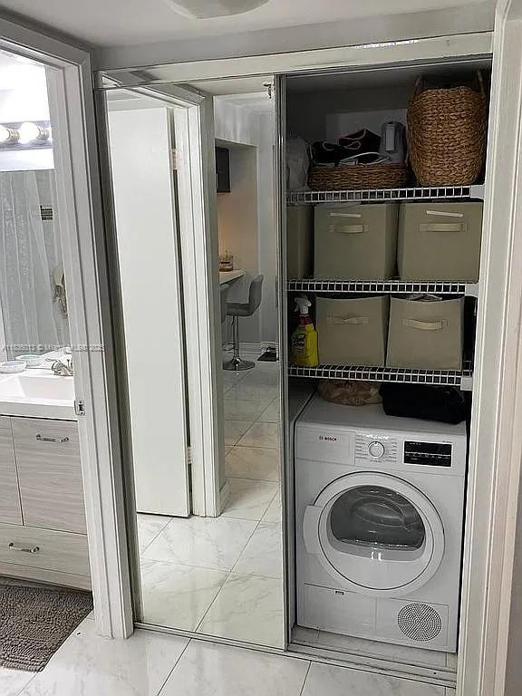 800 N Miami Ave Unit E-707, Miami, FL 33136 - washroom with washer / dryer and light marble finish floors