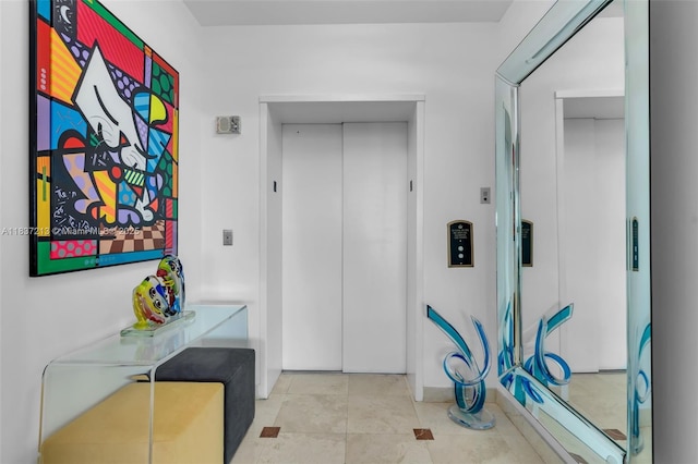 1643 Brickell Ave Unit 1406, Miami, FL 33129 - hall featuring elevator and tile patterned flooring