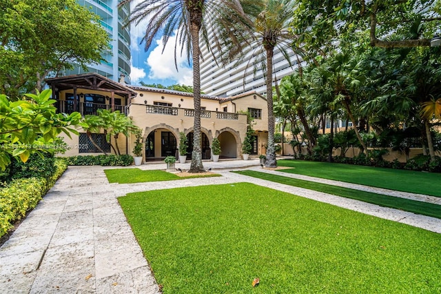 1643 Brickell Ave Unit 1406, Miami, FL 33129 - view of front of home featuring a balcony, stucco siding, and a front yard