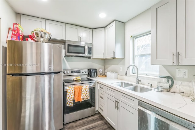 3201 NW 4th Ter Unit 80, Pompano Beach, FL 33064 - kitchen with appliances with stainless steel finishes, light countertops, white cabinetry, dark wood-style flooring, and recessed lighting