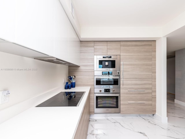 300 Sunny Isles Blvd Unit 5-1605, Sunny Isles Beach, FL 33160 - kitchen with modern cabinets, black electric stovetop, light marble finish flooring, light countertops, and extractor fan