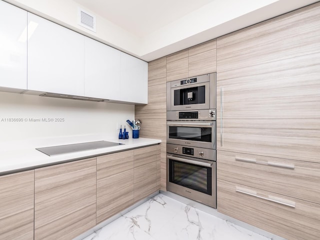 300 Sunny Isles Blvd Unit 5-1605, Sunny Isles Beach, FL 33160 - kitchen featuring modern cabinets, black electric stovetop, light countertops, and light marble finish flooring