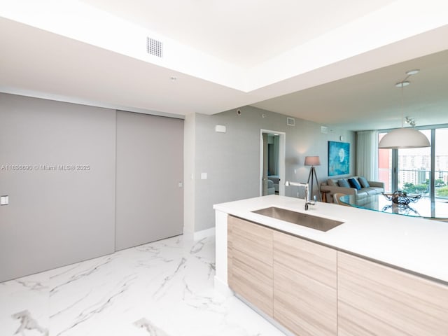 300 Sunny Isles Blvd Unit 5-1605, Sunny Isles Beach, FL 33160 - kitchen featuring modern cabinets, light countertops, open floor plan, and light marble finish floors