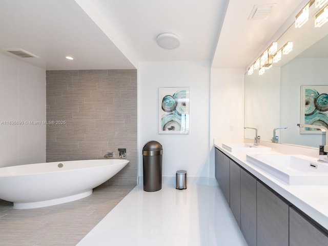300 Sunny Isles Blvd Unit 5-1605, Sunny Isles Beach, FL 33160 - full bathroom with double vanity, a freestanding tub, tile patterned flooring, tile walls, and recessed lighting
