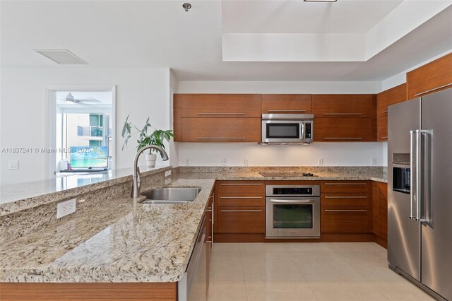 2681 N Flamingo Rd Unit 2508S, Sunrise, FL 33323 - kitchen with appliances with stainless steel finishes, brown cabinets, a peninsula, and modern cabinets