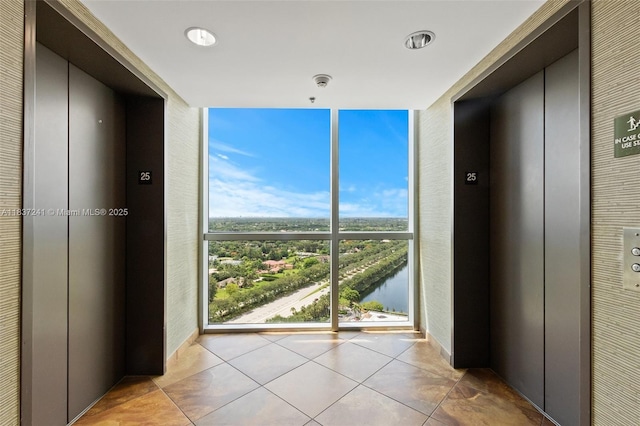2681 N Flamingo Rd Unit 2508S, Sunrise, FL 33323 - hallway with elevator, floor to ceiling windows, tile patterned floors, and a water view