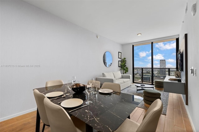 398 NE 5th St Unit 3219, Miami, FL 33132 - dining space with a wall of windows and wood finished floors