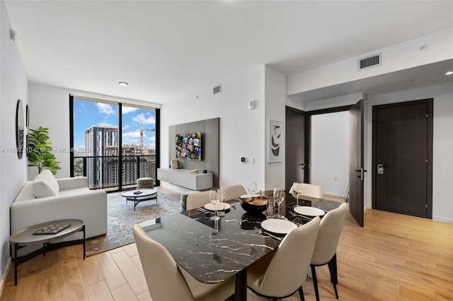 398 NE 5th St Unit 3219, Miami, FL 33132 - dining space featuring light wood-type flooring and floor to ceiling windows
