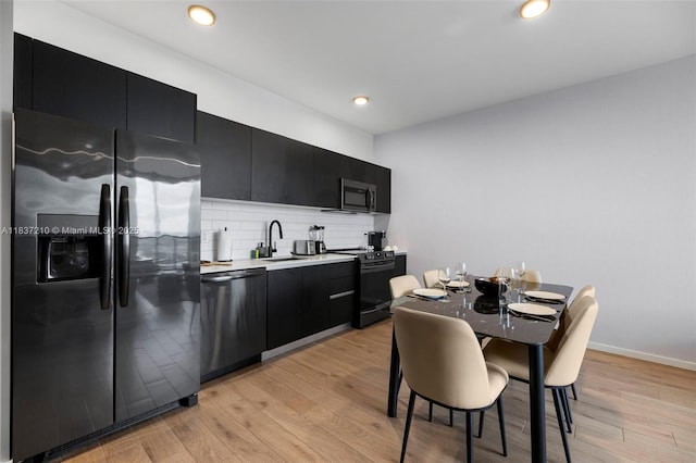 398 NE 5th St Unit 3219, Miami, FL 33132 - kitchen featuring fridge with ice dispenser, dishwashing machine, black electric range, dark cabinets, and recessed lighting