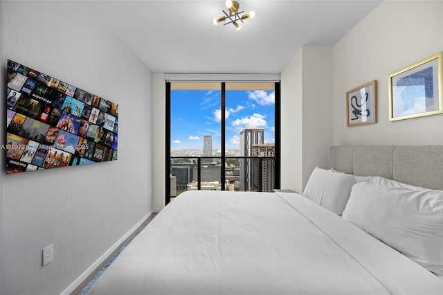 398 NE 5th St Unit 3219, Miami, FL 33132 - bedroom featuring expansive windows, a chandelier, and a city view