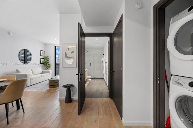 398 NE 5th St Unit 3219, Miami, FL 33132 - laundry room featuring stacked washer / drying machine and light wood-style floors