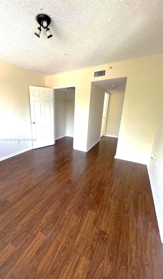 2600 S University Dr Unit 307, Davie, FL 33328 - spare room with dark wood-style floors and a textured ceiling
