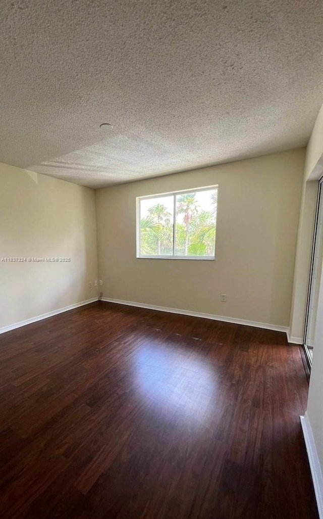 2600 S University Dr Unit 307, Davie, FL 33328 - empty room featuring a textured ceiling and dark wood-style floors