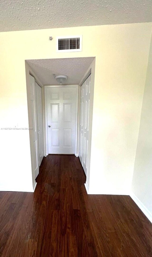 2600 S University Dr Unit 307, Davie, FL 33328 - corridor featuring dark wood finished floors and a textured ceiling