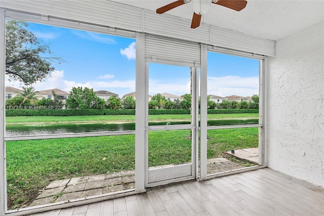 8821 NW 38th Dr Unit 103A, Coral Springs, FL 33065 - unfurnished sunroom with ceiling fan, a water view, and a residential view