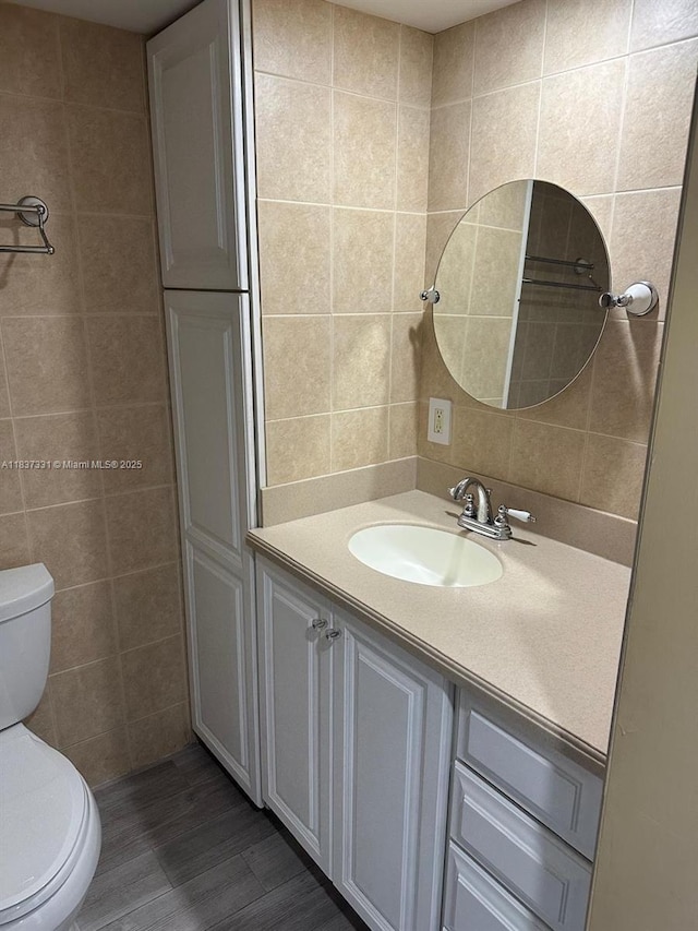 661 N University Dr Unit 1-201, Pembroke Pines, FL 33024 - bathroom with tile walls, wood finished floors, and vanity