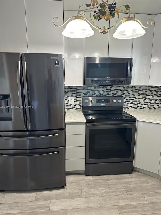661 N University Dr Unit 1-201, Pembroke Pines, FL 33024 - kitchen with stainless steel appliances, light countertops, wood tiled floors, and tasteful backsplash