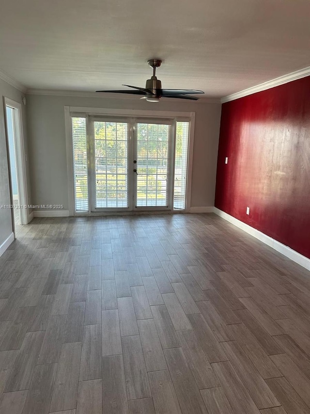 661 N University Dr Unit 1-201, Pembroke Pines, FL 33024 - unfurnished room featuring ornamental molding, wood finished floors, a ceiling fan, and plenty of natural light