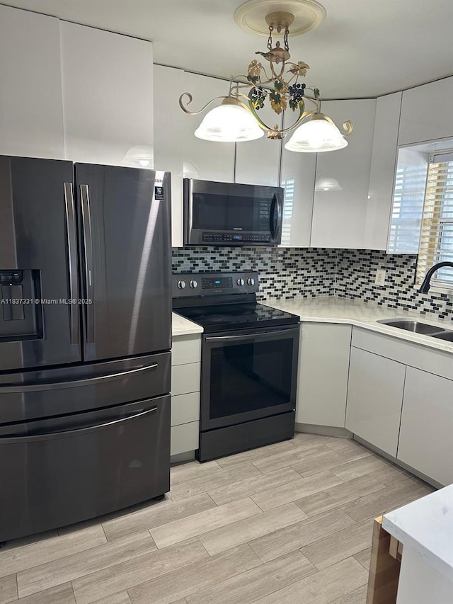 661 N University Dr Unit 1-201, Pembroke Pines, FL 33024 - kitchen featuring fridge with ice dispenser, black / electric stove, and light countertops