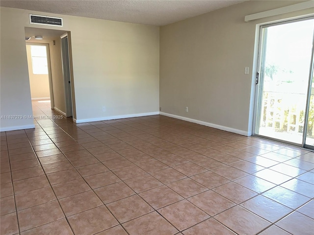 1720 Funston St Unit 111, Hollywood, FL 33020 - empty room with light tile patterned flooring and a textured ceiling