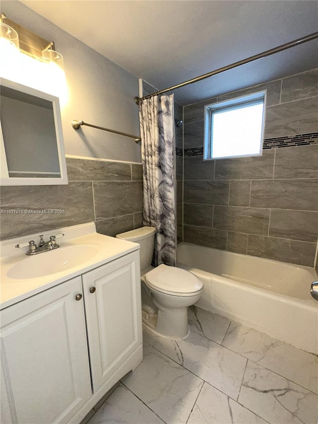 1720 Funston St Unit 111, Hollywood, FL 33020 - bathroom featuring marble finish floors, vanity, tile walls, shower / bath combo with shower curtain, and wainscoting