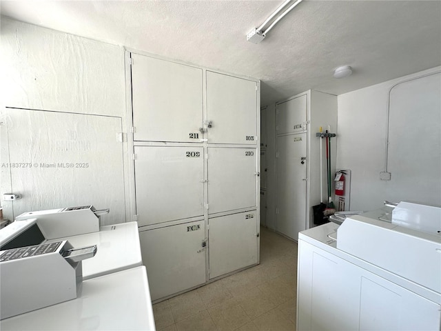 1720 Funston St Unit 111, Hollywood, FL 33020 - washroom featuring cabinet space, washer / clothes dryer, light flooring, and a textured ceiling