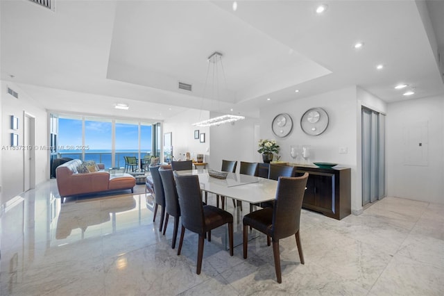 18201 Collins Ave Unit 1006, Sunny Isles Beach, FL 33160 - dining area featuring a tray ceiling, electric panel, light marble finish floors, recessed lighting, and floor to ceiling windows