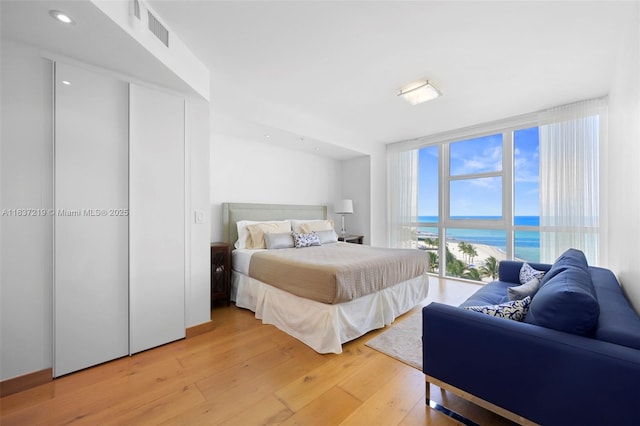 18201 Collins Ave Unit 1006, Sunny Isles Beach, FL 33160 - bedroom featuring light wood finished floors, a water view, and recessed lighting