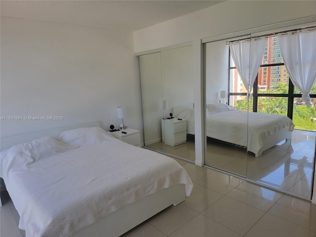 17021 N Bay Rd Unit 1015, Sunny Isles Beach, FL 33160 - bedroom featuring two closets and light tile patterned flooring