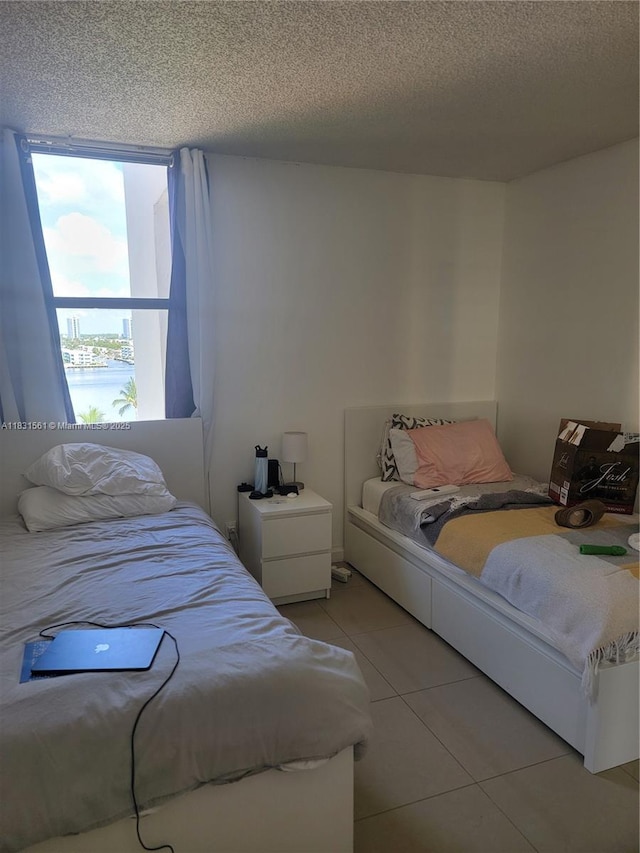 17021 N Bay Rd Unit 1015, Sunny Isles Beach, FL 33160 - bedroom featuring light tile patterned flooring and a textured ceiling