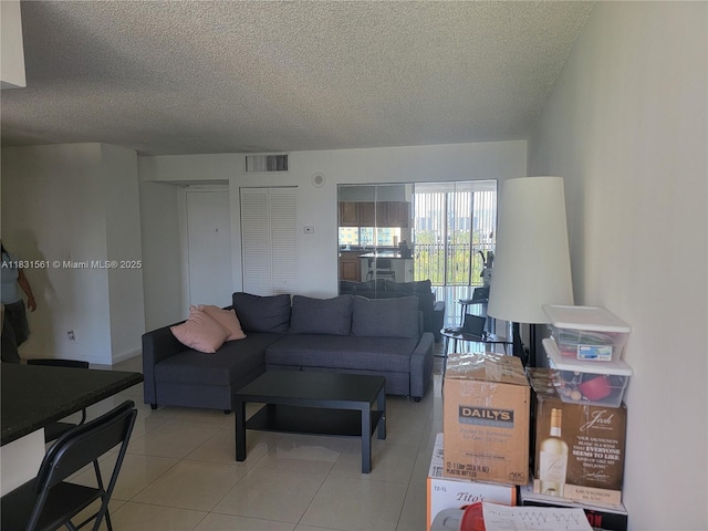 17021 N Bay Rd Unit 1015, Sunny Isles Beach, FL 33160 - living room with a textured ceiling and light tile patterned flooring