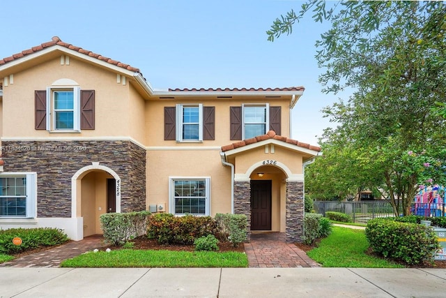 4326 Braxton Ave, West Palm Beach, FL 33417 - view of front of home featuring stone siding, stucco siding, and a tiled roof