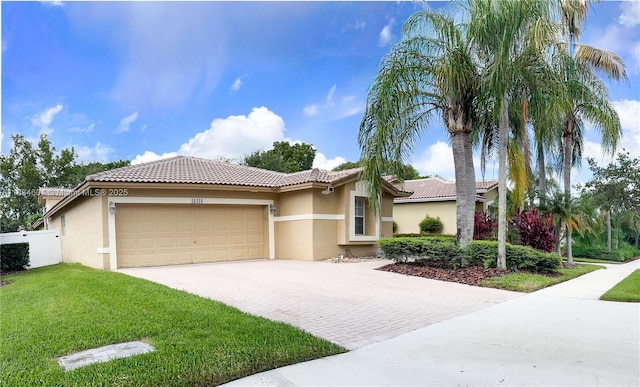 16410 Sapphire Bnd, Weston, FL 33331 - mediterranean / spanish-style house featuring stucco siding, driveway, a garage, and a tile roof
