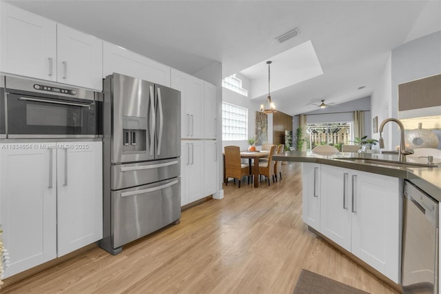 16410 Sapphire Bnd, Weston, FL 33331 - kitchen with stainless steel appliances, white cabinetry, light wood-style floors, and ceiling fan
